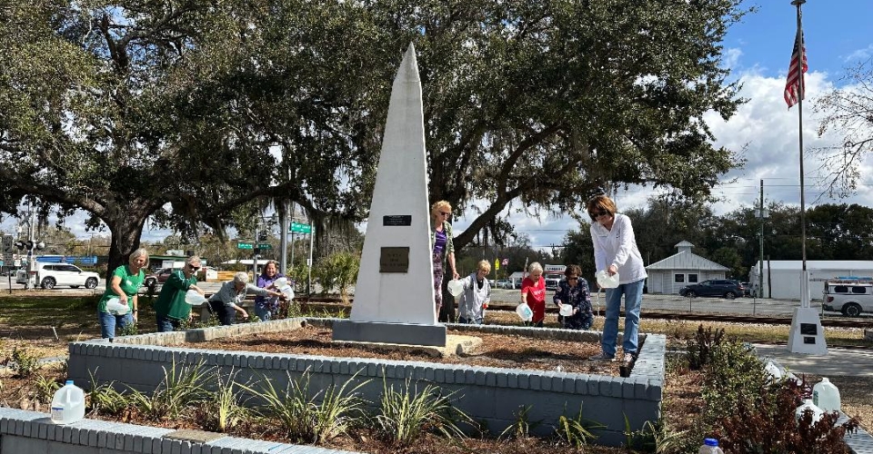 Watering Plants at the Lutz Memorial