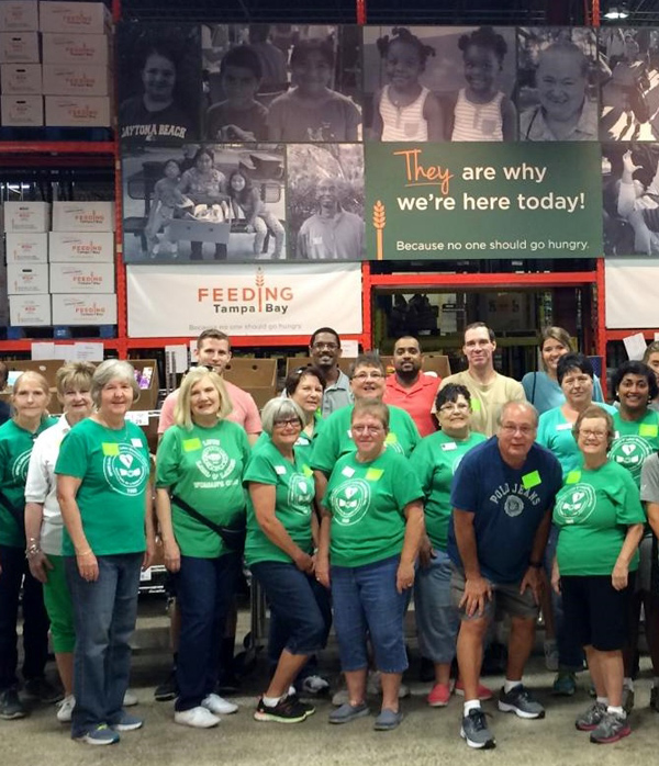 Green Shirt Members volunteering at “Feeding Tampa Bay Warehouse