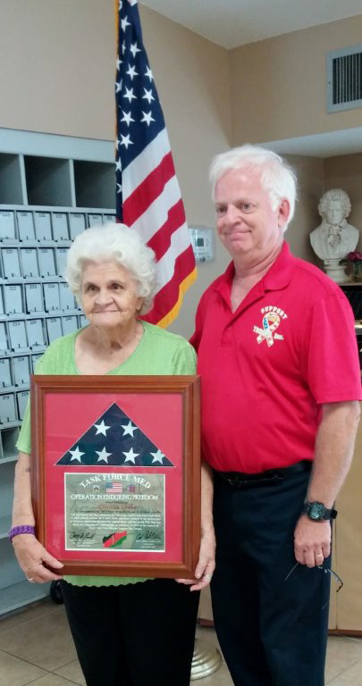Gloria Dale being presented with award by Mark Van Trees, Dir. of “Support the Troops”
