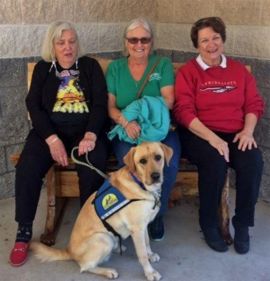 Photo:  (l-r) Members Nancy Fisher, Andrea Sands and Chair Edwina R. Kraemer with recent graduate puppy