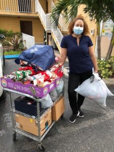 Maryvette DeLeon, Administrator of a Tampa ALF, receiving residents’ gifts