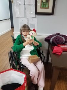 Nursing Home Resident Cuddling Teddy Bear