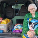 Club member delivering pet food, beds and supplies to Pasco Animal Shelter