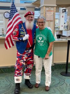 Patriotic Santa Vet greeter with club member Dolores Tarafa