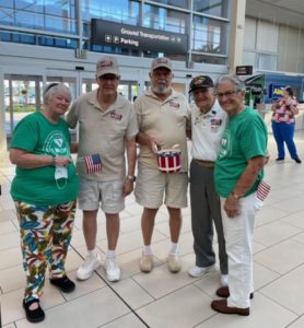 Club members flanking 3 vet greeters of Honor Flight  