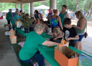 Members assisting children with crafts