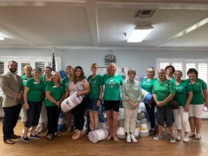 Club members delivering comforters for distribution