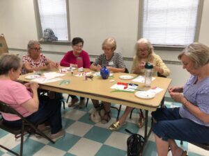 Club members learning the quilling process