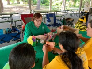 Club Member Showing How to Make Paper Flowers