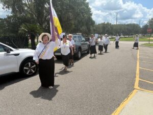 Club Members reenacting a march to pass the 19th amendment.