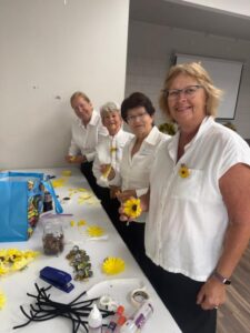Making sunflower pins. Sunflowers were the symbol of the Suffragettes. 