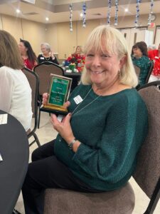 Volunteer of the Year Showing Off Her Award