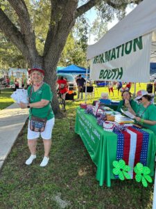 Club Member, Helen Fornino, handing out brochures in front of the Information Booth.