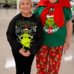 Christmas in July event chair, Darlene Choe (on right) with member, Dee Knerr, model their Grinch Inspired clothing.