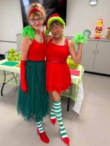 Pam Blumenthal and Grace Walters (l-r) modeling their "Grinch Inspired" clothing.